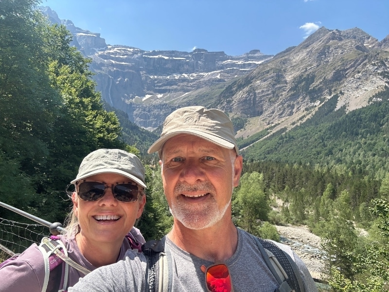 selfie image a couple taken with huge limestone mountain cirque in the background