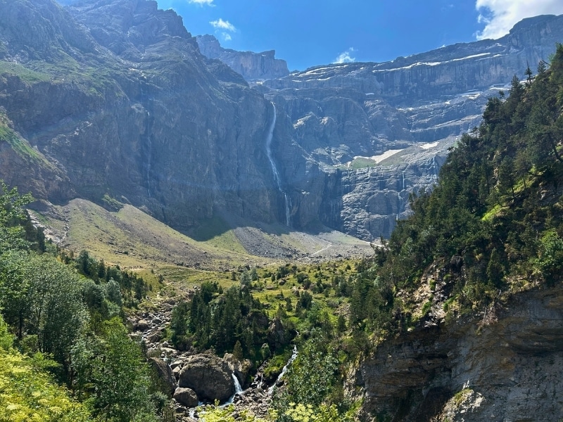Cirque de Gavarnie in July with waterfalls, streams and lush grassy meadowsn