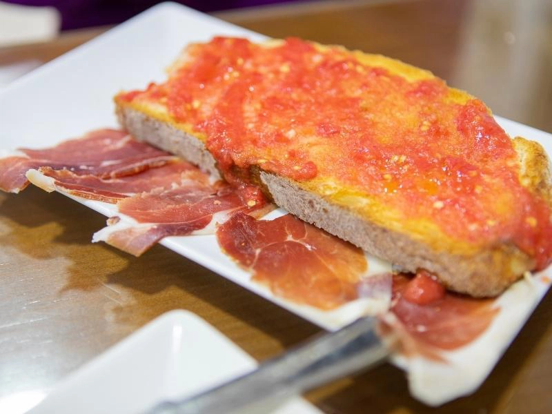 plate of jamon and bread with tomato and olive oil