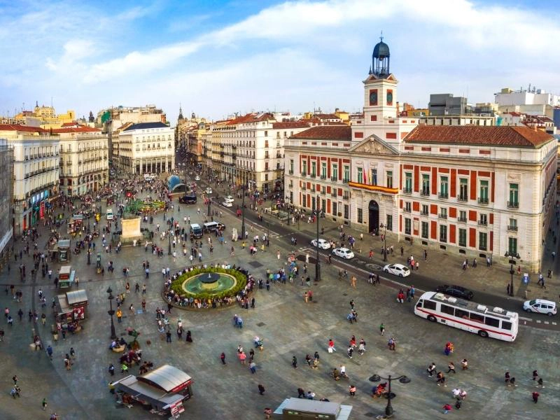 Busy city square with imposing historic buildings