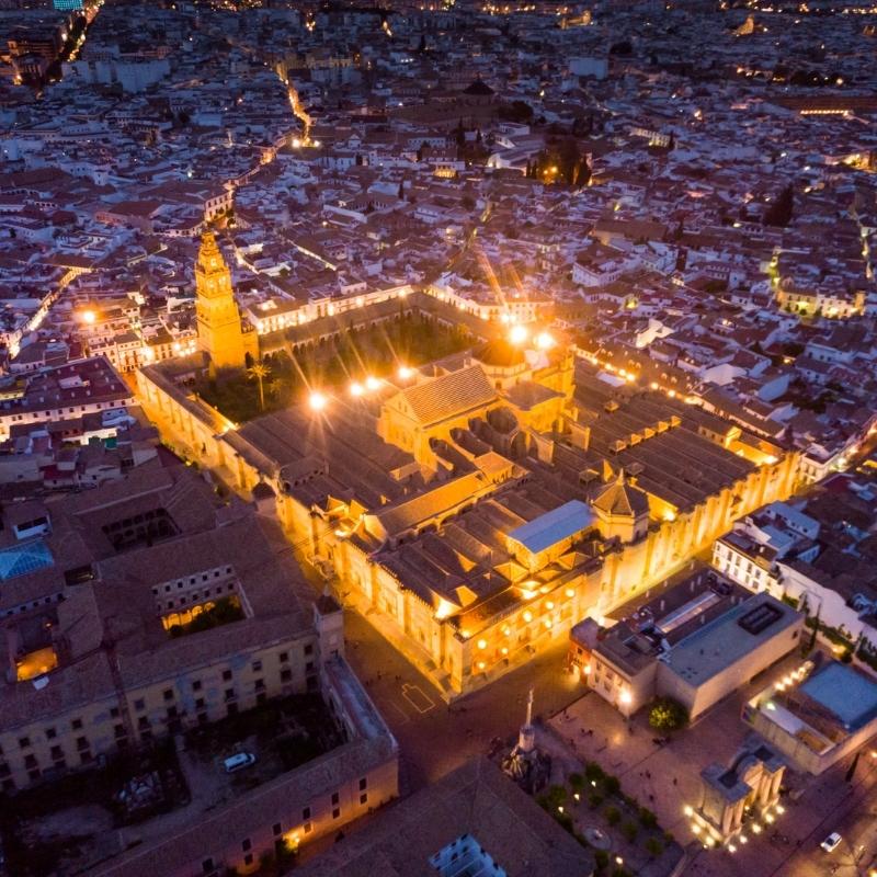 Huge mosque cathedral building seen from above and lit up at night
