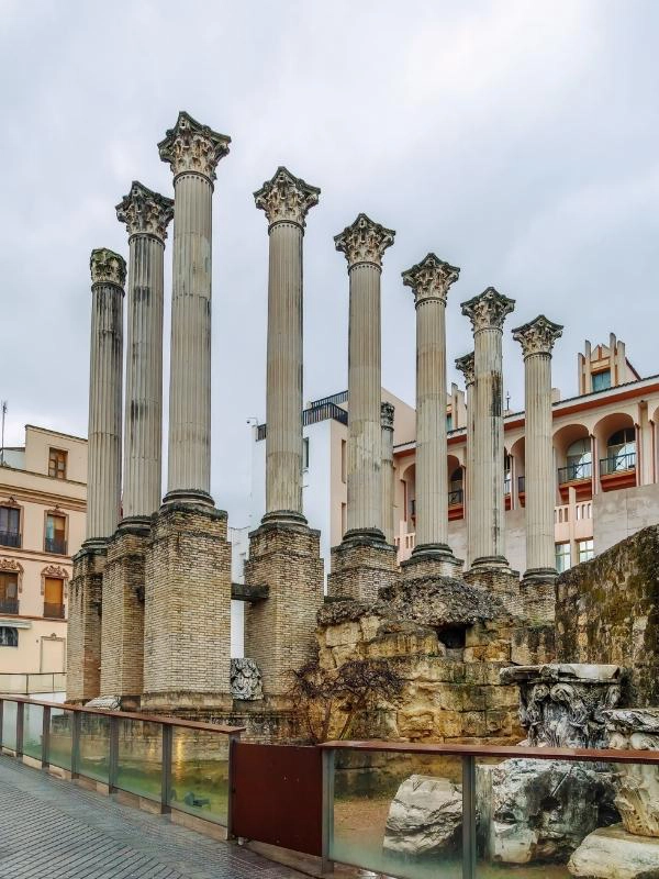 round roman columns atop brick square columns with parts or a ruined building