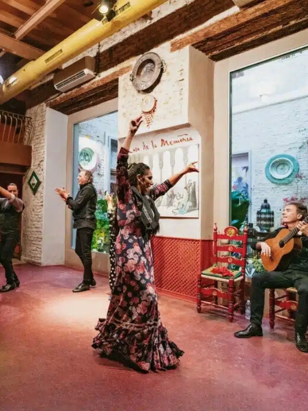 flamenco dancers and a guitarist on a stage