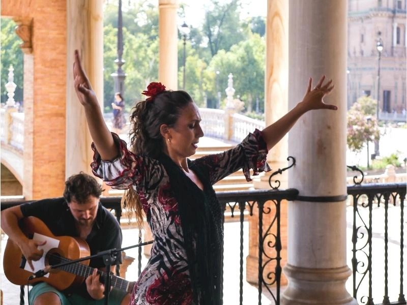 flamenco dancer and guitar player in shaded portico