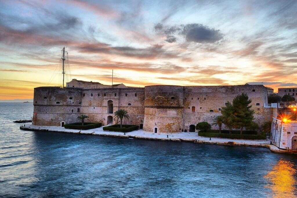 A large castle built jutting out into the sea