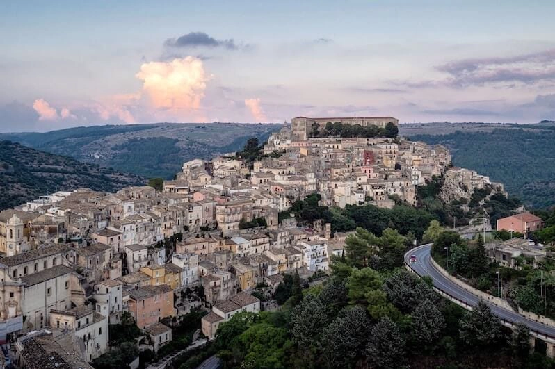 an Italian hilltop town with houses stacked together