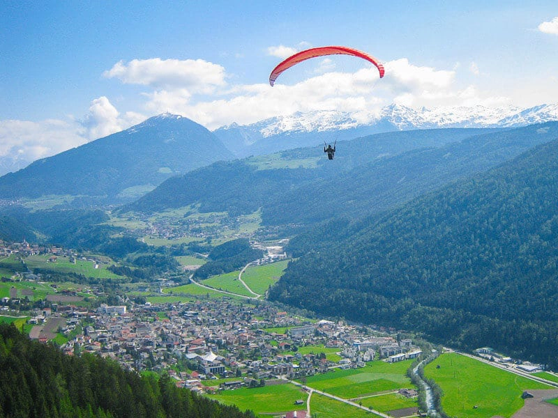 paraglider over an alpine valley