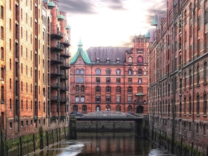 Large red brick office buildings lining a canal