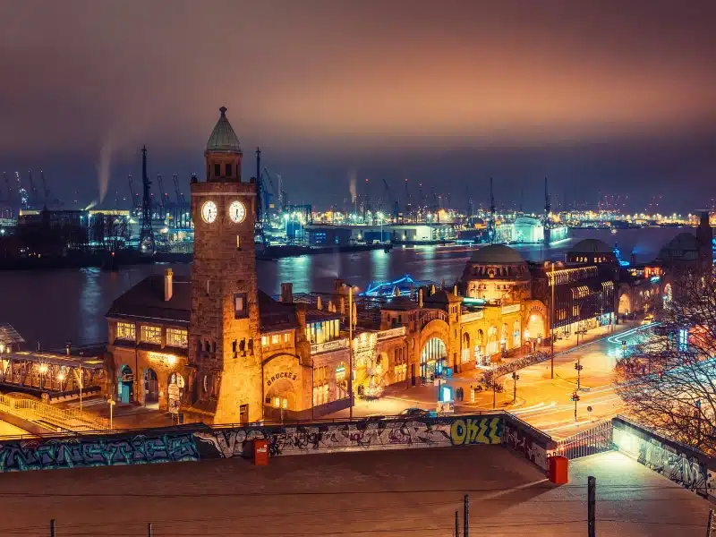 Illuminated St. Pauli Piers in Hamburg, the floating piers at Hamburg harbor, at night. 