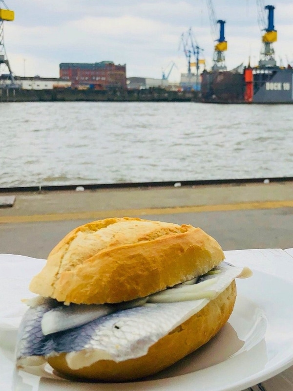 Fish roll in Hamburg with the port in the background