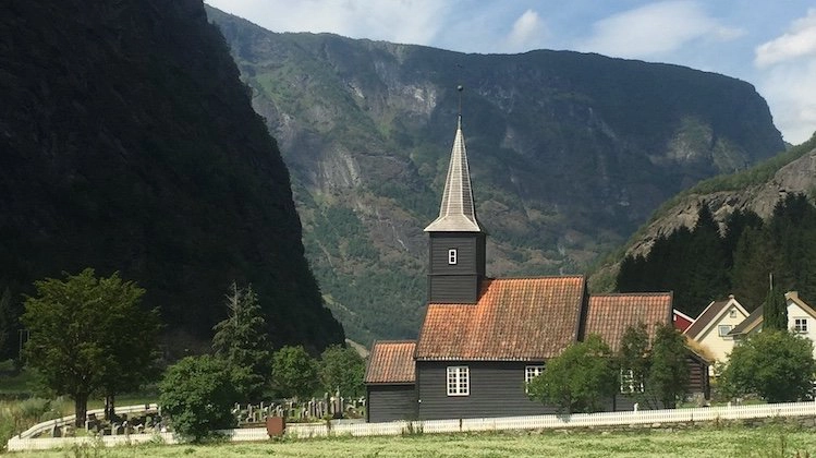 black clapboard church with clay tiled roof