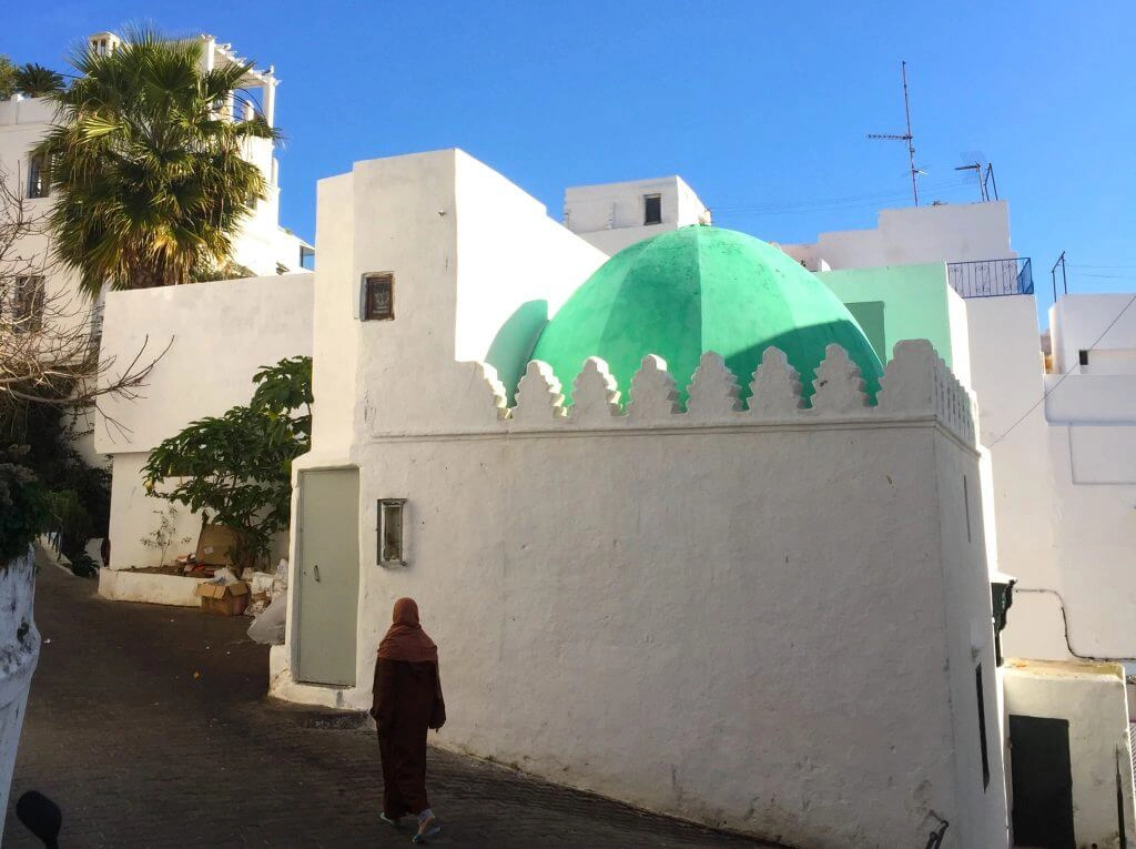 Traditional white Moroccan buildings with a green dome