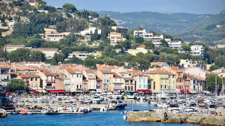 Getty images - Colourful houses and yachts in front of pine covered hills