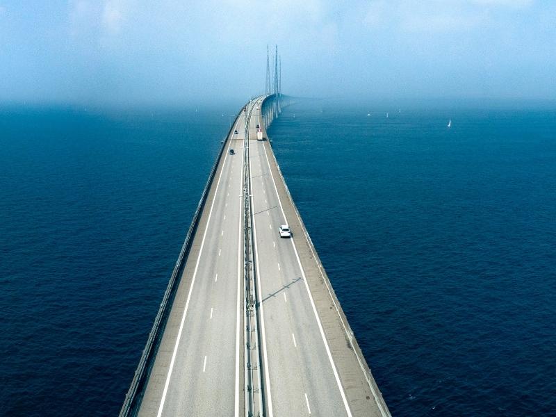 large road bridge across a deep blue sea