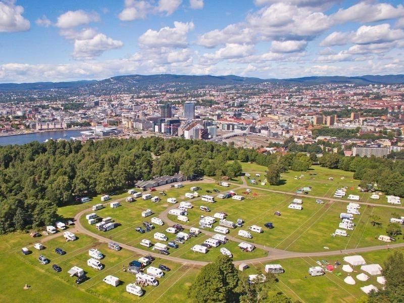 green camping field with motorhomes and campervans parked close to Oslo