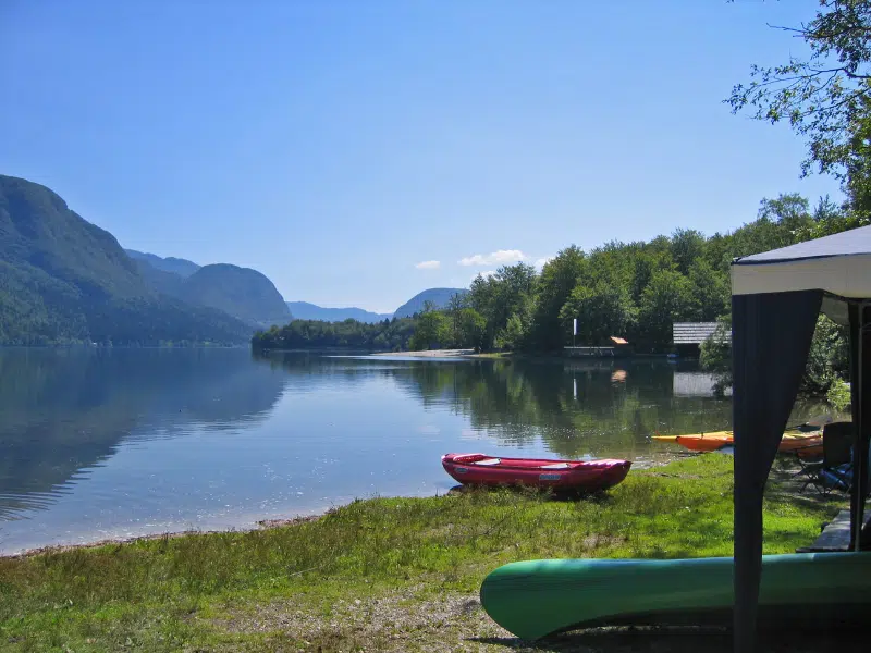 Mirror lake with paddle boards and kayaks at the edge