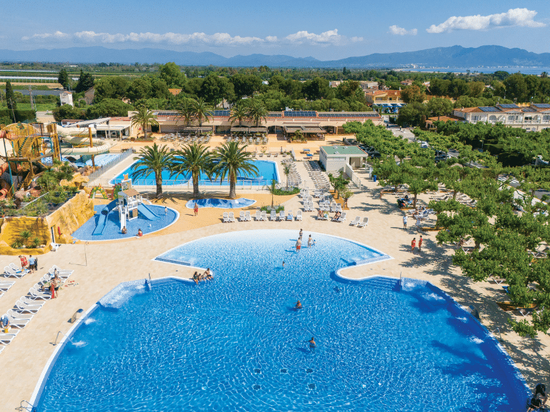Swimming pool complex of a campsite surrounded by trees