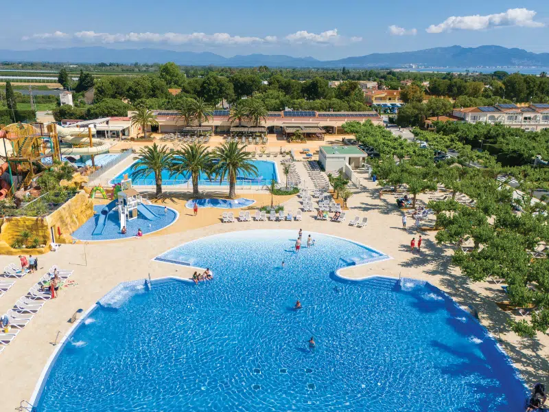 Swimming pool complex of a campsite surrounded by trees