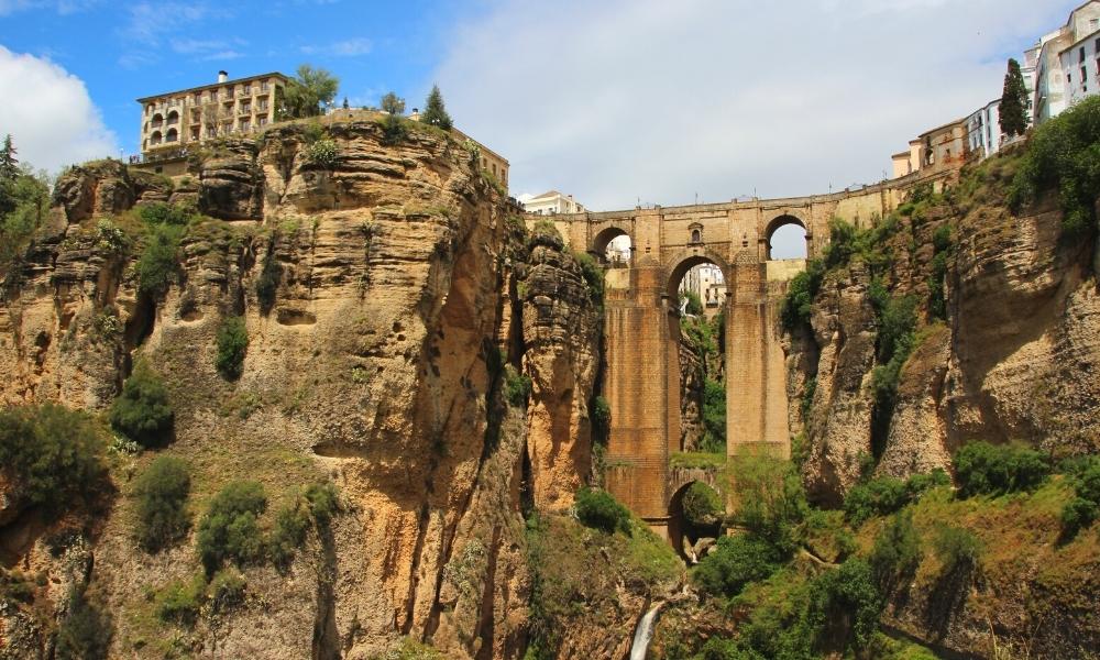 Spanish town perched on a cliff above a gorge and bridge