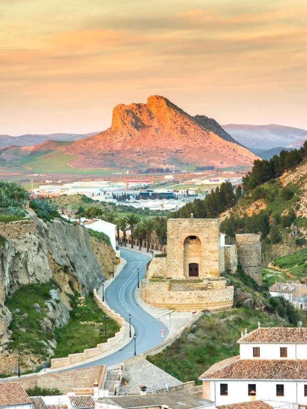 White town in Spain with large rock in the distance