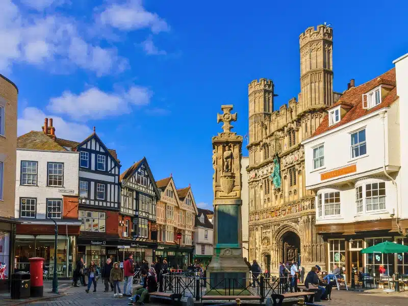 Street scene with the Christchurch Gate of the cathedral, locals and visitors, in Canterbury, Kent, England, United Kingdom