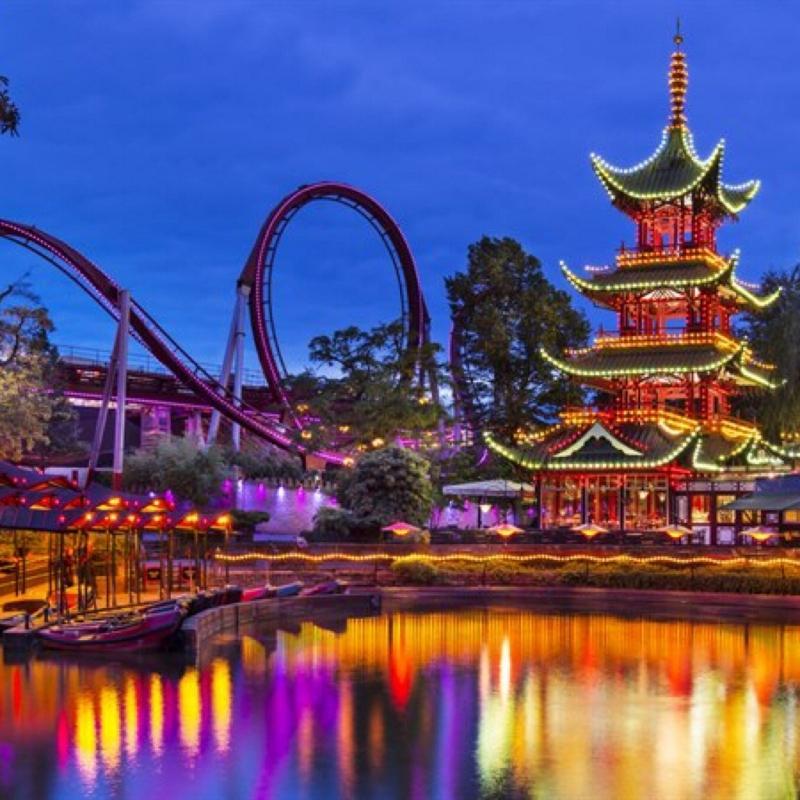 Bright lights on a Japanese style building and a roller coaster