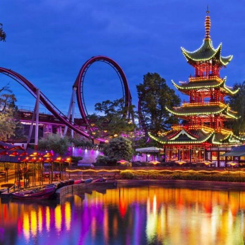Bright lights on a Japanese style building and a roller coaster