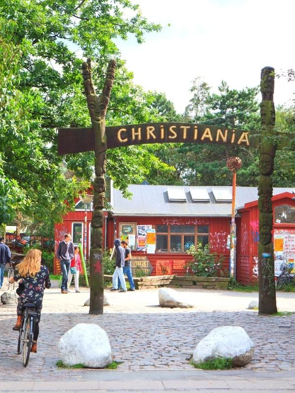 Christiania sign on wood with a red building behind