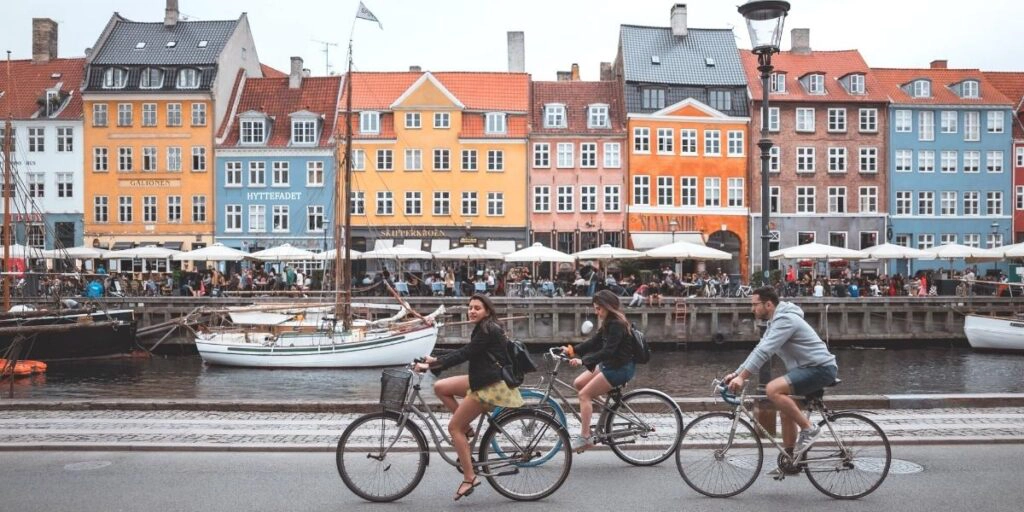 colorful houses and people riding bicyles along Nyhavn