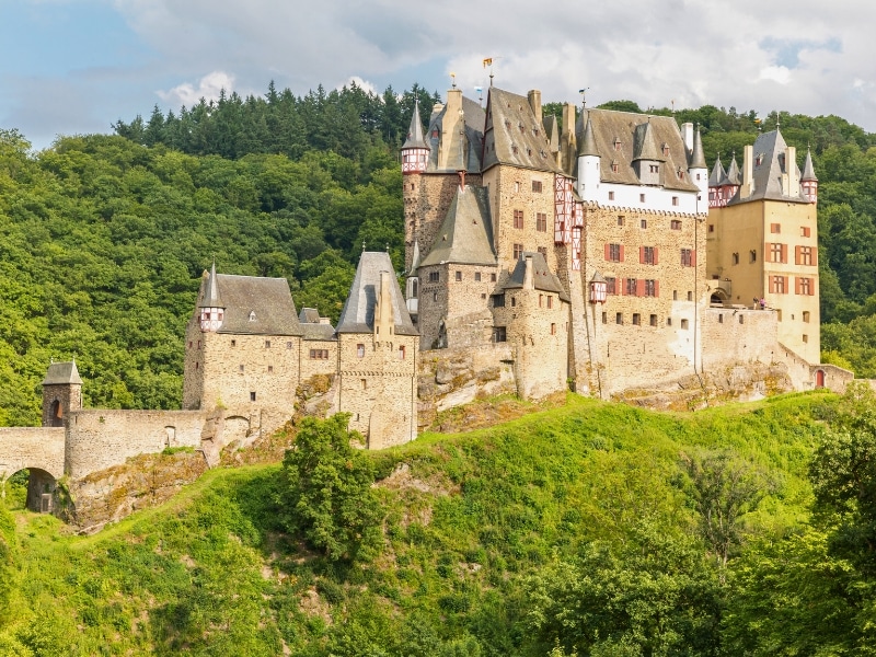 honeyed stone medieval turreted castle with drawbridge