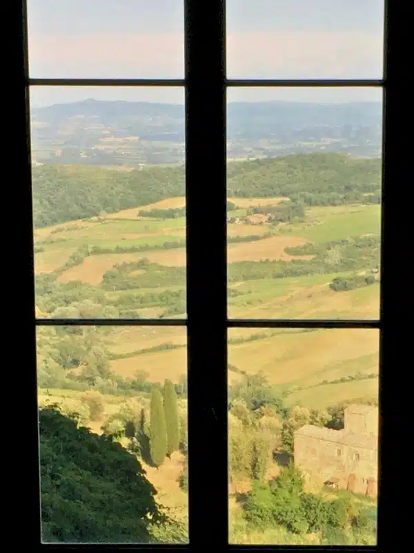 Wide from a traditional six paned window across lush countryside