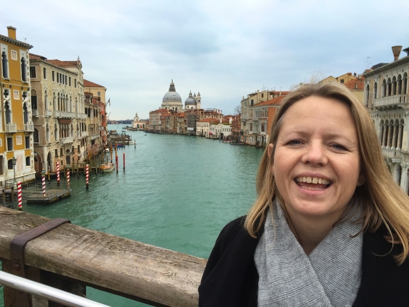 Woman on a bridge over the grand canal with 