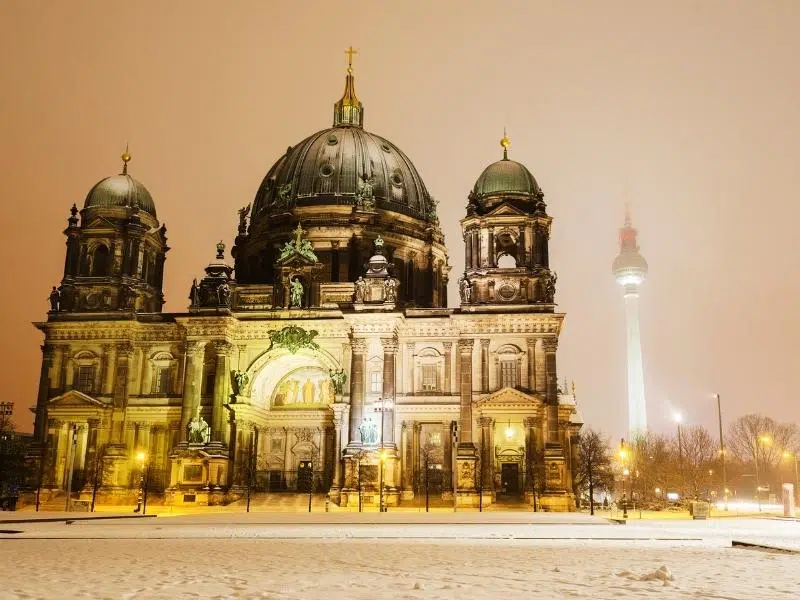 Domed cathedral at twilight surrounded by snow
