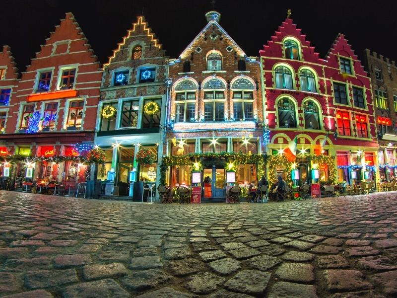 Row of traditional Belgian gabled houses brighly pained and decorated for Christmas