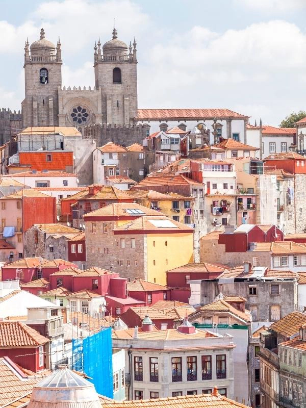 colourful city rooftops with a twin towerd cathedral in the distance