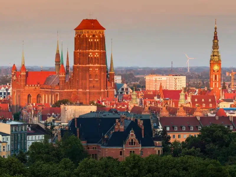 large brick church dominating the ciy skyline at golden hour