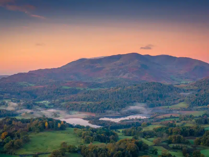 dramtic Lake District fell with a setting sun behind it