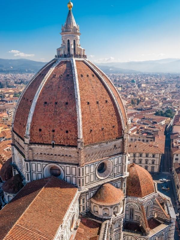 Terracotta dome with a city scape spread beneath