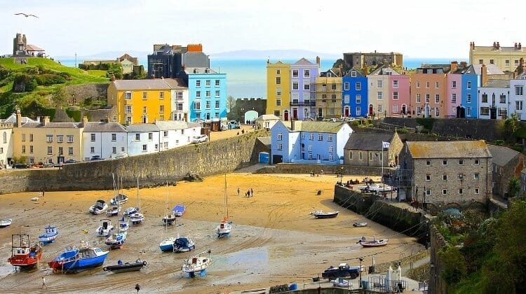 Tenby with colourful houses, beach and small fishing boats