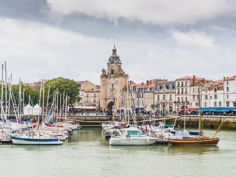 small boats in an old port surrounded by historic buildings