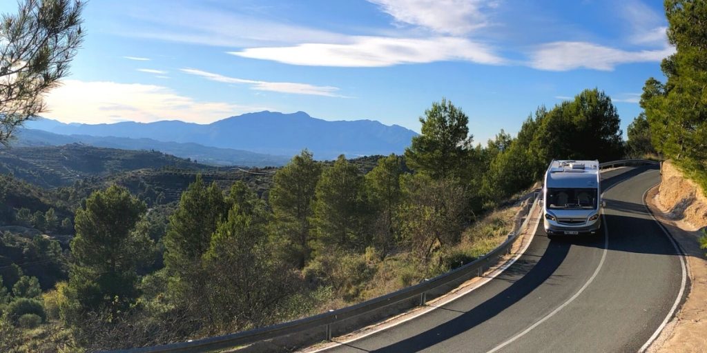 Motorhome on a road in Spain with blue skies and mountains