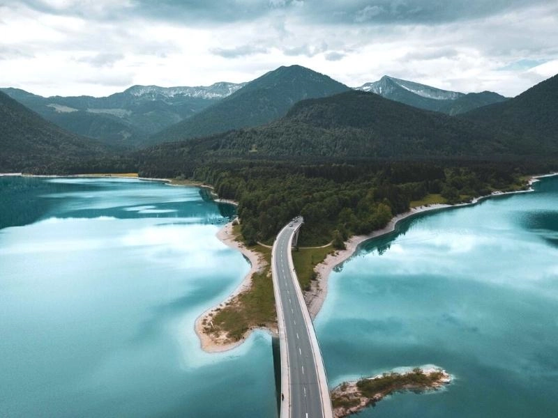 road in germany across mountains and a lake