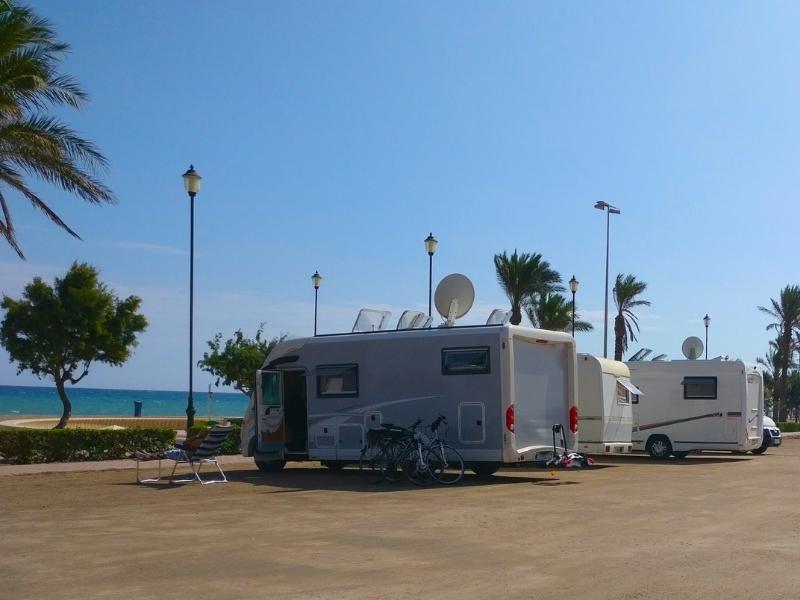 Spanish motorhome aire by the sea with palm trees
