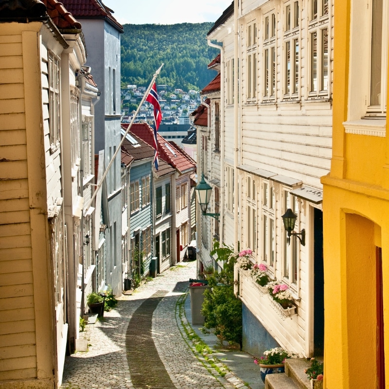 cobbled hilly street lined with colourful wooden houses