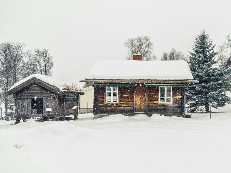 wooden huts in a snowy landscape