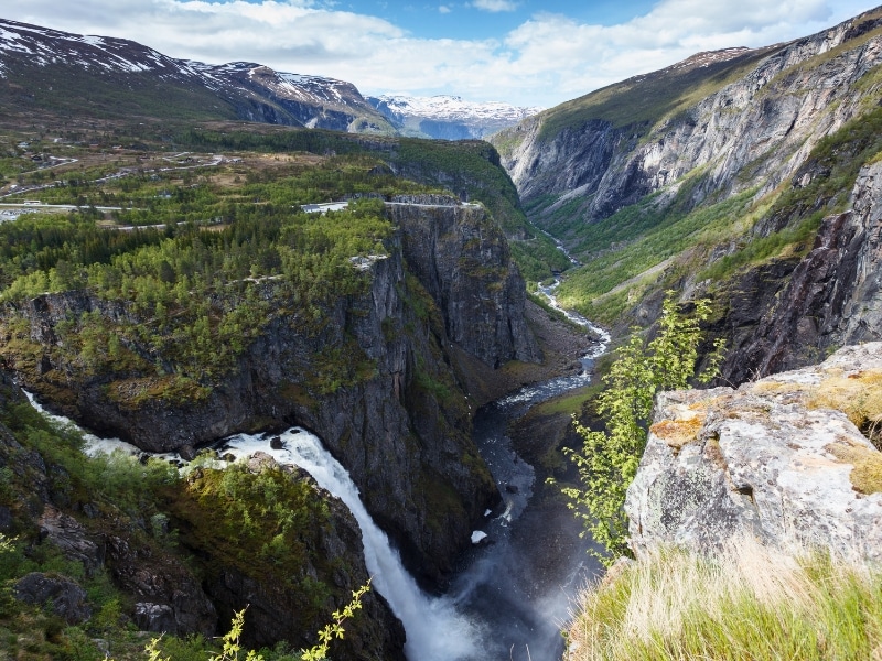 tall waterfall thundering into a river gorge