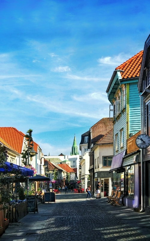 cobbled street of shops, cafes and buildings