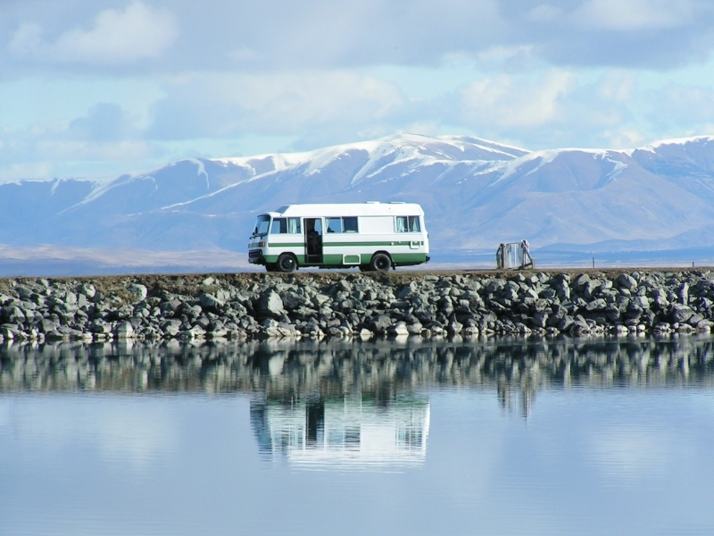 motorhome wild camping by water with mountains