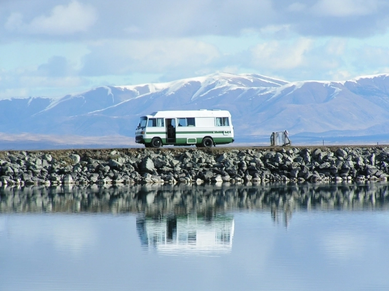 motorhome wild camping by water with mountains