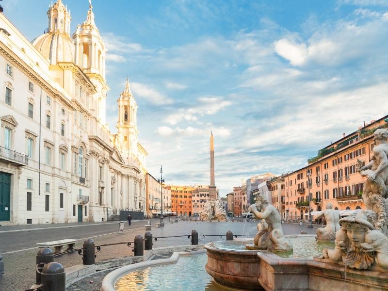 oblong square in Rome with statues, fountains and an obelsik